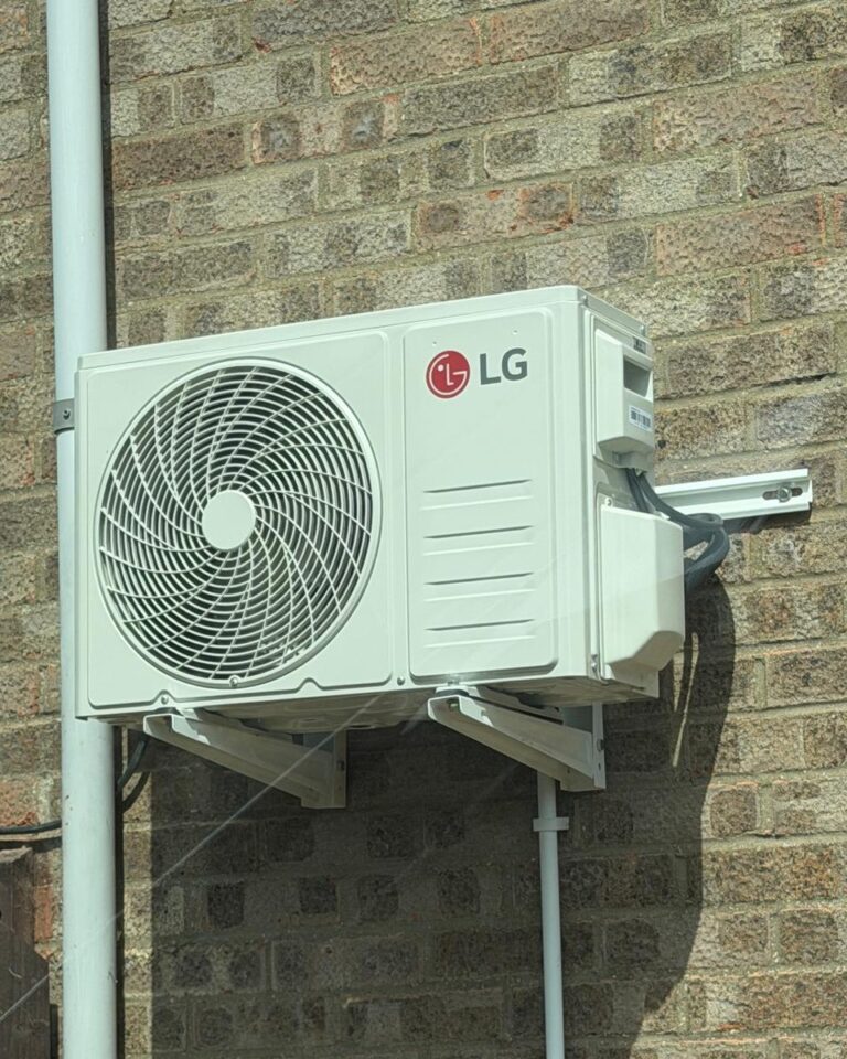 Outdoor air conditioning unit on a wall bracket on a brick wall